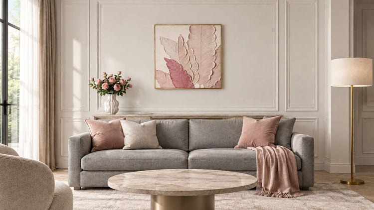 Large textured framed wall art hung above a grey sofa in a neutral living room