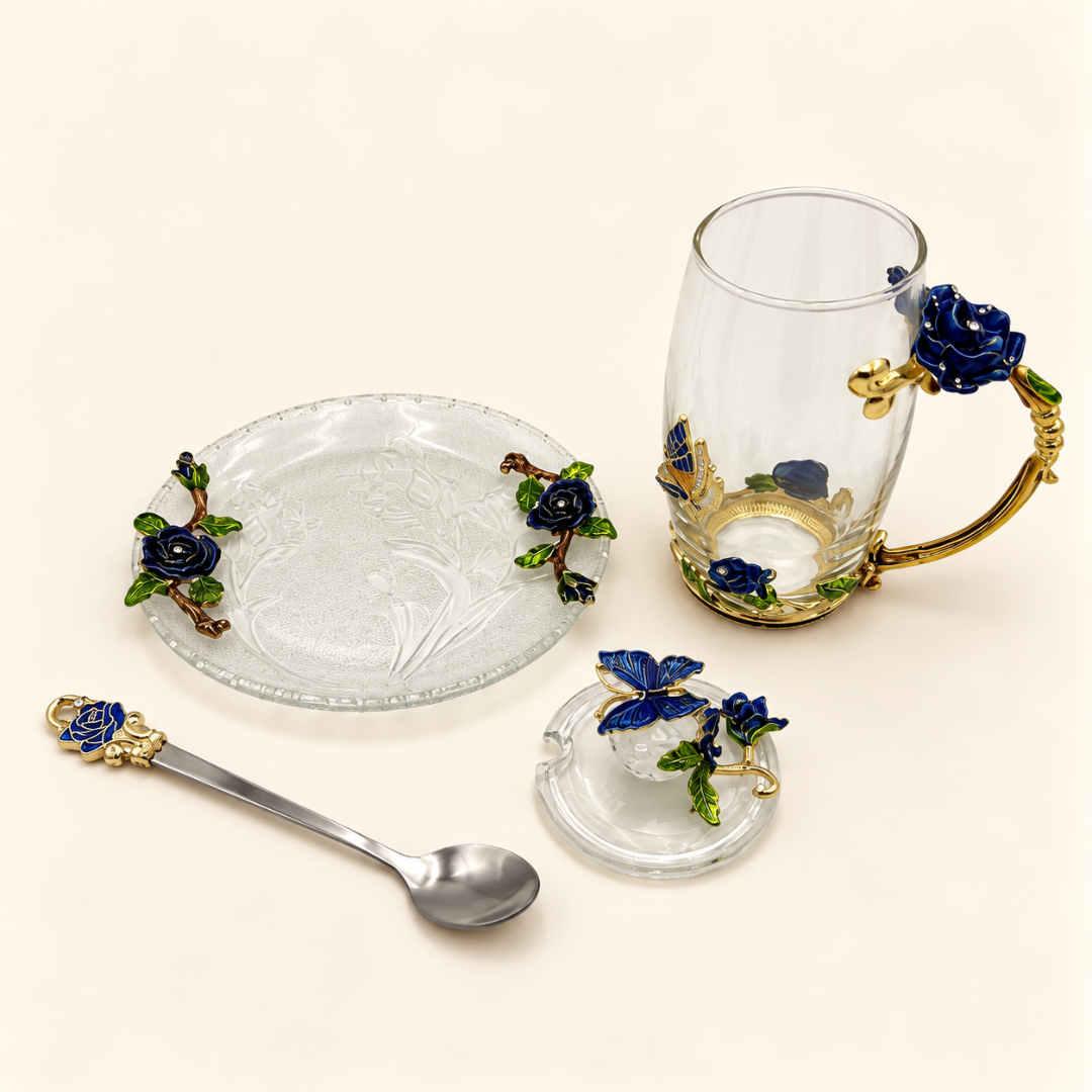 Glass tea cup and saucer set with metal blue rose flowers laid out with lid and spoon