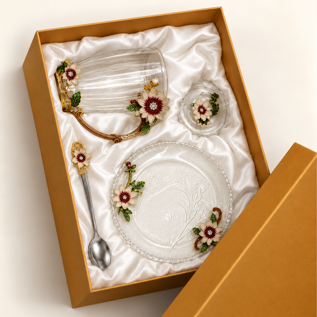 Glass tea cup and saucer set with metal pink and gold flowers in its lined gift box