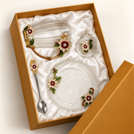 Glass tea cup and saucer set with metal pink and gold flowers in its lined gift box