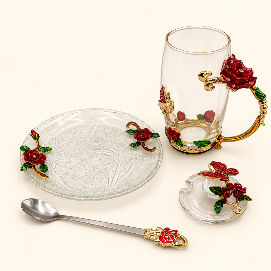 Glass tea cup and saucer set with metal red rose flowers laid out with lid and spoon