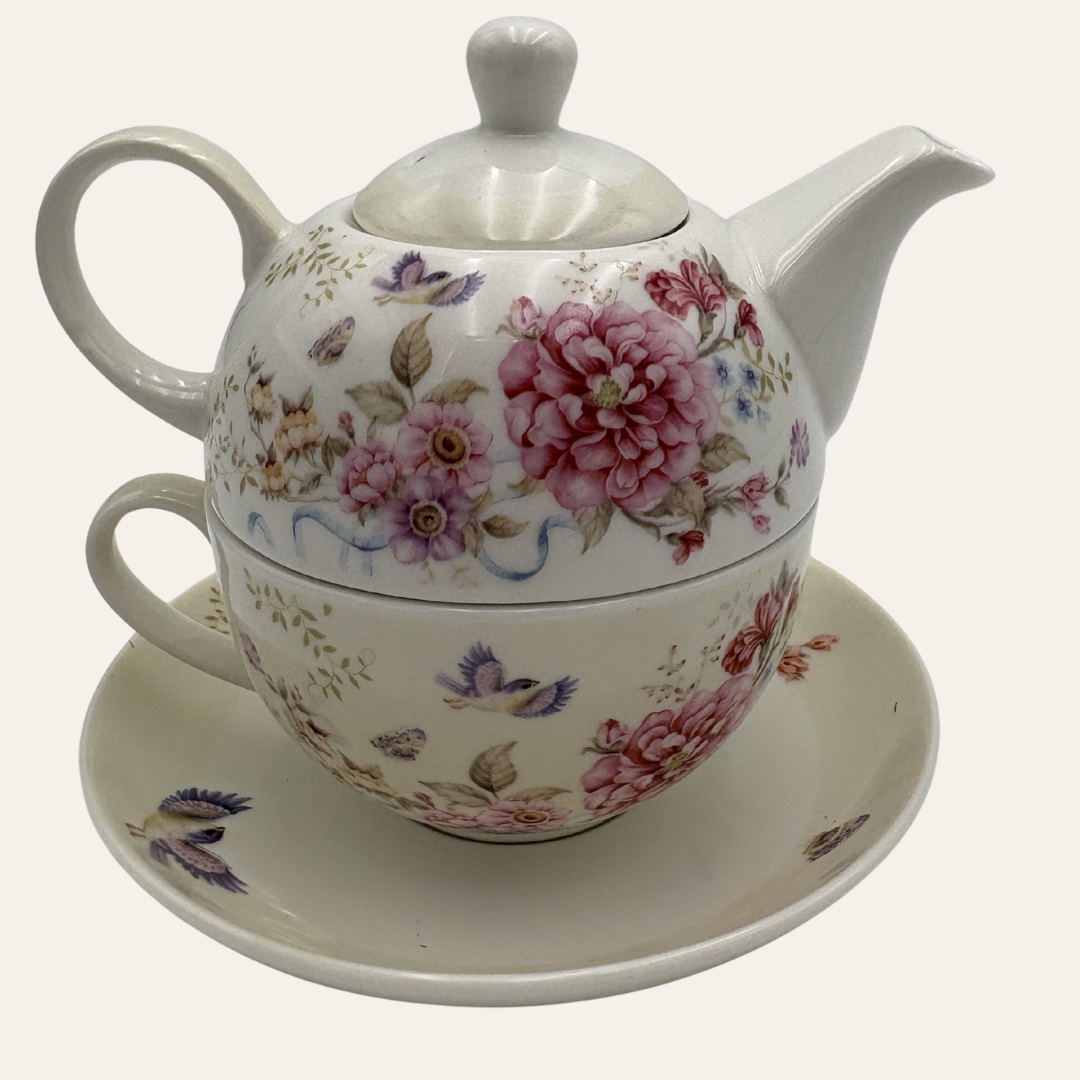 White tea for one set with pink flowers and butterflies on a white background
