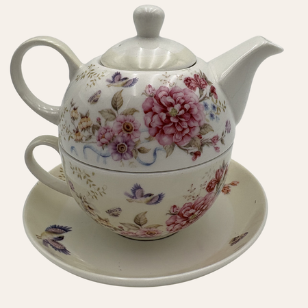 White tea for one set with pink flowers and butterflies on a white background