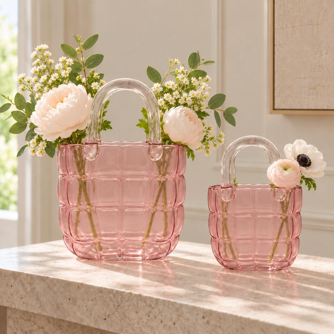 Large and small pink quilted glass handbag vases with fresh flowers styled together