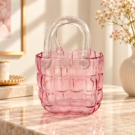Empty pink quilted glass handbag vase showing the clear glass handles and padded pattern
