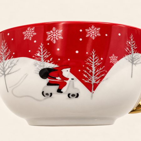 Close-up of the cup showing Santa on a scooter in a snowy winter scene