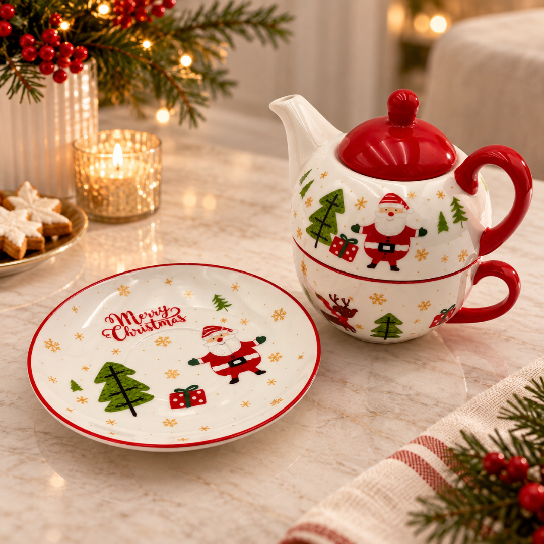 Santa teapot stacked on its cup beside the Merry Christmas saucer on a festive table