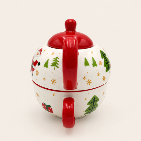 Back view of the Santa teapot showing the red handle and Christmas tree design