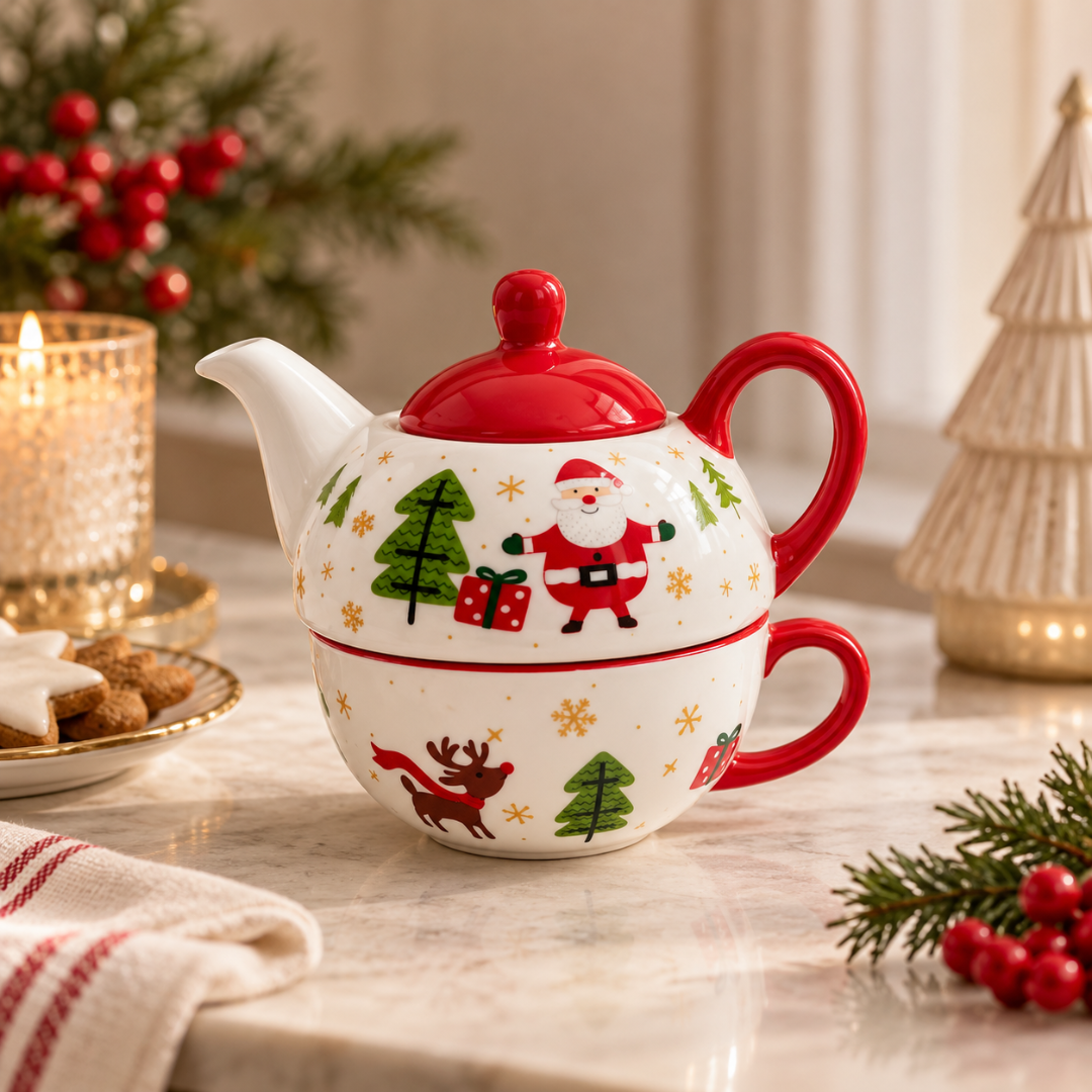 Santa Christmas teapot stacked on its cup on a marble table with Christmas decorations